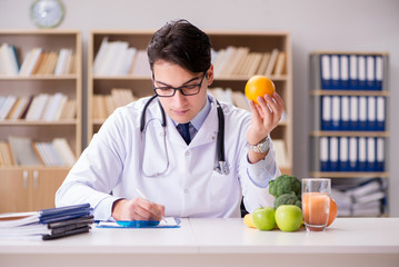 Doctor in dieting concept with fruits and vegetables