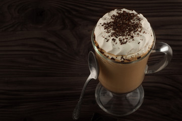 Hot viennese coffee with whipped cream on dark background