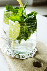 Clean drinking water with lemon, lime and mint. Selective focus.