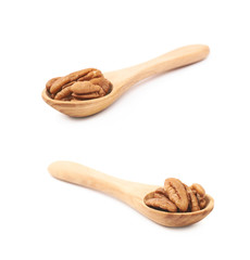 Spoon of pecan nuts isolated
