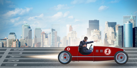 Businessman riding vintage roadster in motivation concept