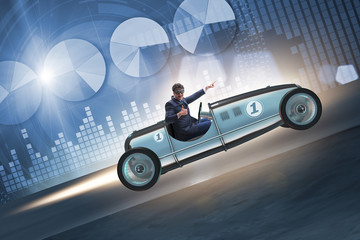 Businessman riding sports car against charts
