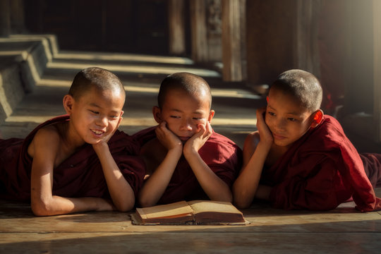 Burmese novices or three priests are reading happily in the classroom. Counting the development of education in Mandalay Myanmar