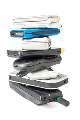 stacked of old and obsolete mobile phone on white