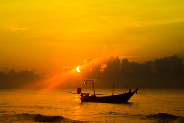 Beautiful Sunset on the beach Yellow Sky with sailing boat