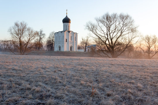 View to the Church of the Intercession of the Holy Virgin on the Nerl River in sunlight.