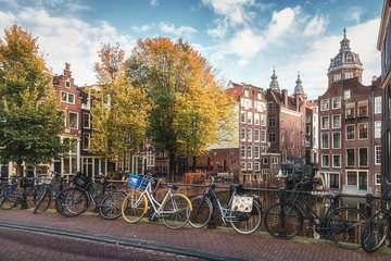 Fototapeta premium The canal houses along the junction of the canals Oudezijds Voorburgwal and Oudezijds Achterburgwal