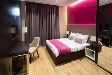 Interior of a hotel bedroom with bathroom