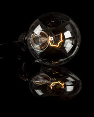 Single incandescent light bulb that is power up and glowing