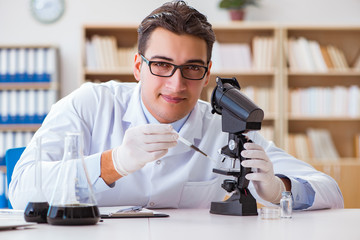 Chemical engineer working on oil samples in lab