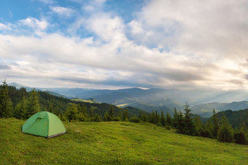 The tent is set on the slopes of the Carpathian Mountains.