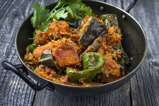 Indian Vegetable Curry Fry with Sweet Potatos and Eggplant  as close-up in a Korai