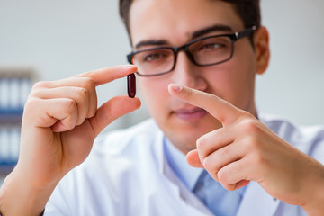 Doctor holding medicines in the lab