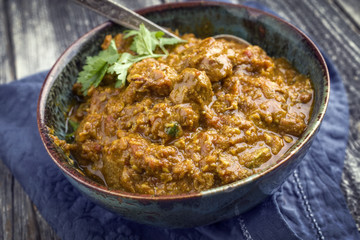 Traditional Indian Lamb Curry as close-up in a Korai