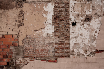 Damaged wall with bricks and concrete