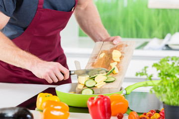 Man preparing food for cooking in kitchen