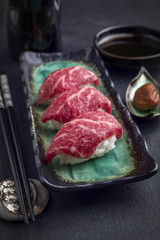 Traditional Japanese Wagyu Nigiri Sushi with Umiboshi as close-up on a bowl
