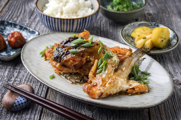 Traditional Japanese Sake Kama  Broiled Salmon Collar in Teriyaki Sauce as close-up on a plate