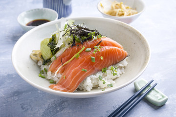 Traditional Japanese Hokkaidon  Thinly sliced salmon Donburi as close-up in a bowl