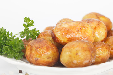 Homemade Potatoes. Young roast potato with parsley, closeup