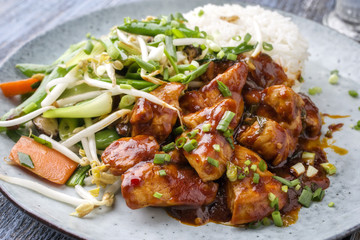 Chicken sweet-sour with Vegetable and white Rice as close-up on a plate