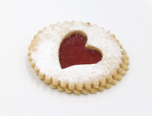 Pastry cookie cake dessert with a red jam heart and icing powder sugar - Isoalted, white background, copy text space