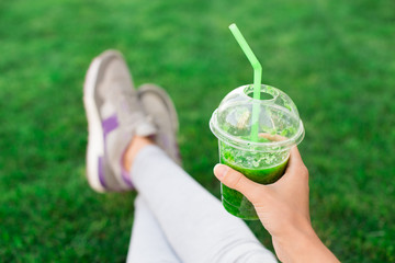 Young woman drink smoothie healthy detox outdoors