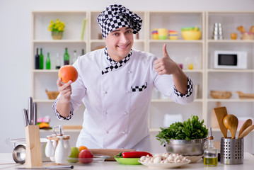 Young male cook working in the kitchen