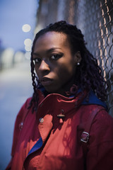 A portrait of a young, black woman with braids in Brooklyn, New York City. Shot in the streets...