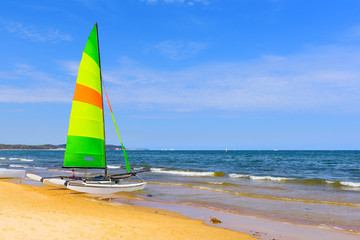 Colorful catamaran on the Sopot beach in sunny day. Baltic Sea. Poland.