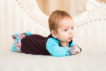 Portrait of adorable baby boy lying on tummy