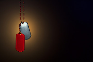 Military ID tags on a dark background
