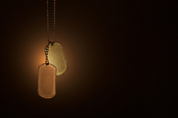 Military ID tags on a dark background
