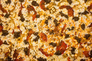 Background of delicious cooked pizza with sausage, peppers, onions, and mozzarella cheese