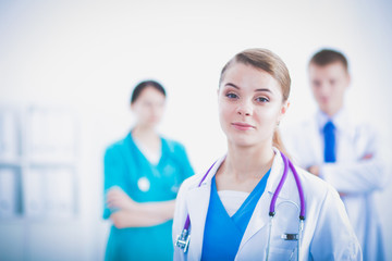 Fototapeta premium Attractive female doctor in front of medical group