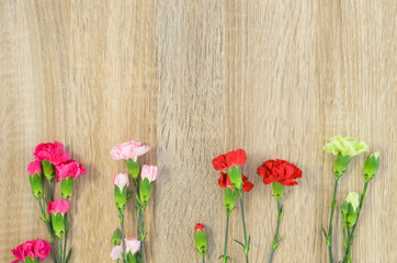 Flowers lie on a wooden surface and place for text.