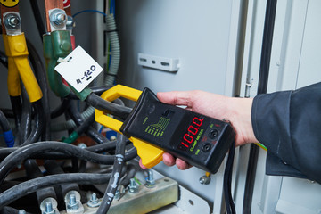 Fototapeta premium electrician measurements with multimeter tester