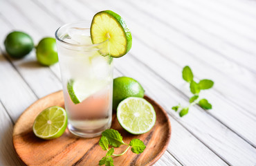 Refreshing lime drink with ice cubes in a glass jar