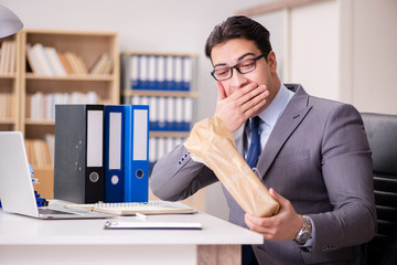 Naklejka premium Businessman receiving parcel in the office