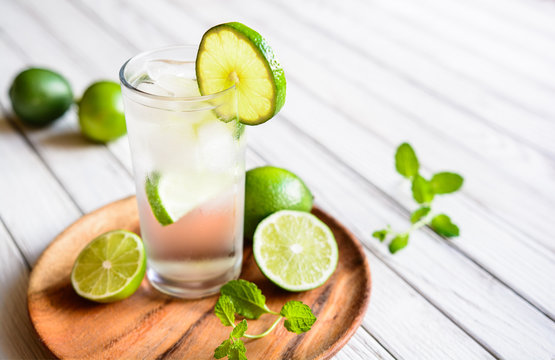 Refreshing lime drink with ice cubes in a glass jar