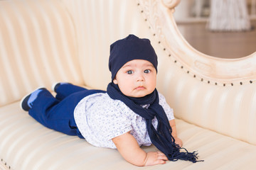 Child, childhood and infant concept - close-up of happy little baby boy at home