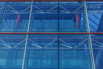 Front view of a blue building of many windows