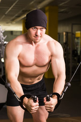 Fototapeta na wymiar handsome bodybuilder works out excercise in gym