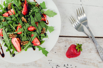 Fresh salad with arugula and strawberries