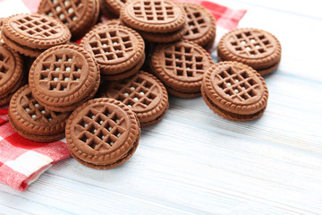 Chocolate cookies with cream on white wooden table
