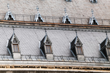 Fototapeta premium Dormer windows on the roofs of gothic building