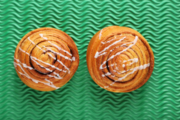 Cinnamon buns on green background