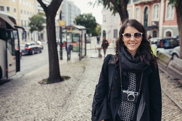 Excited woman looking surprised and amazed,smiling,looking up.Young tourist backpacker woman excited,overwhelmed,looking at something amazing on her trip.Traveling on beautiful places.Admiring