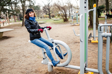 Friends of the tourists are training at sports and fitness in the park on the street public free gym