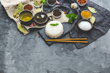 Boiled Dish Rice with vegetables and spices over dark rustic background. Vegetarian Asian food concept.